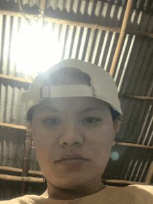 a person wearing a white baseball cap with the letter o on it