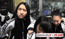 a woman making a face in front of a sign that says 17 live