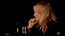 a woman sits in a chair with her hand on her chin and the words #svu on the bottom right