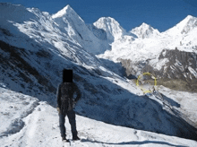 a person standing on a snowy mountain with a yellow circle in the middle