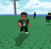 a man in a green shirt with the letter b on it