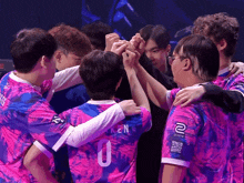 a group of people are huddled together with one wearing a number 0 jersey