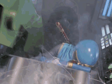 a person in a blue suit is laying on a table with a sword in their hand