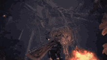 a person is flying through the air in front of a large fire .
