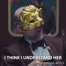 a man with a mask on his face is holding a glass of wine and says i think i understand her