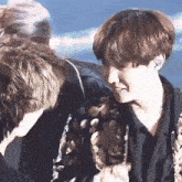 a group of people are standing next to each other and one of them is smiling