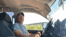a man is sitting in the driver 's seat of his car
