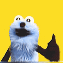 elmo from sesame street is giving a thumbs up with a lollipop .