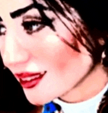 a close up of a woman 's face with red lips .