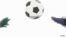 a soccer player is kicking a ball while another player watches