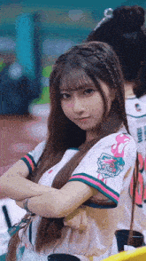 a girl wearing a shirt that says ' fisher ' on the sleeve