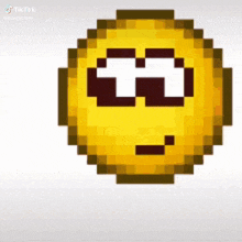 a pixel art smiley face with a slight smirk on its face