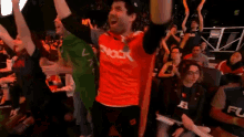 a man in a red shirt that says shock