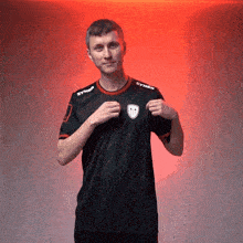 a man wearing a black shirt with syner written on the sleeves