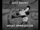 a black and white cartoon of mickey mouse steering a ship .