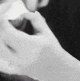 a black and white photo of a person 's hands with a blurred background