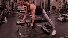 a man is lifting a dumbbell on a bench in a gym with the word grays in the background
