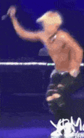 a shirtless man is dancing in front of a blue background that says ' mgm ' on it