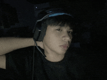 a young man wearing headphones with a microphone