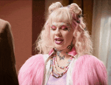 a woman with pink hair and a pink fur coat