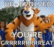 a tony the tiger mascot is standing in front of a chain link fence with people behind it .