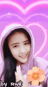a girl wearing a purple hoodie with a flower in front of a pink heart
