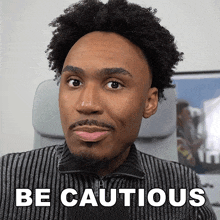 a man with curly hair and a beard says " be cautious "