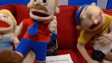 a group of stuffed animals are sitting on a couch .