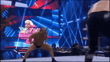 a man in a wrestling ring with a sign that says aew on it