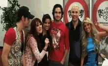 a group of people are posing for a picture in front of a sign that says rbd .