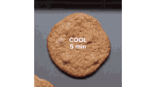 a cookie is sitting on a tray that says cool 5 min