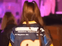 a woman wearing a black and yellow jersey with the number 2 on it .
