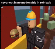 a man in a hard hat is holding a hamburger in a roblox video game .