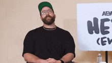 a man sitting in front of a sign which says he 's crew