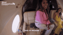 two women are sitting on a plane with the words this is insane below them