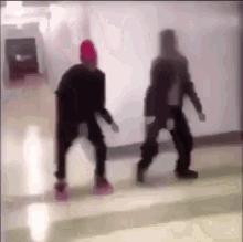 two people are dancing in a hallway in a blurry photo .