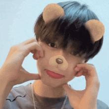 a young man wearing a teddy bear mask makes a funny face