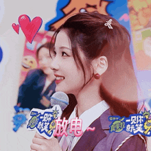 a woman is holding a microphone with a sign that says ' laugh ' on it