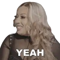 a woman with long blonde hair is smiling and the word yeah is on her face