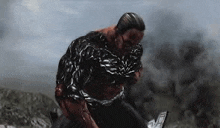 a man is being attacked by a monster in a video game while holding a gun .