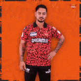 a man in a red shirt that says dream11