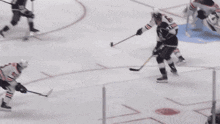 a hockey game is being played in front of an enterprise ad