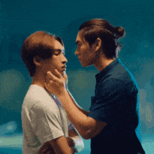 two men are touching each other 's faces in a pixelated image