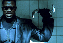 a man wearing sunglasses and a black leather jacket is holding a sword