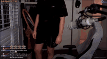 a man stands in front of a microphone on a twitch channel
