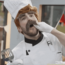 a man wearing a chef 's hat and apron is holding a spatula in his hand