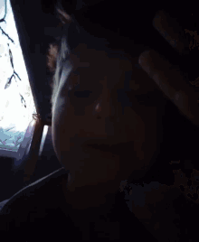 a young boy is making a funny face with his eyes closed and his mouth open