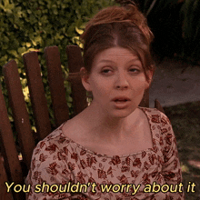 a woman sitting in a wooden chair with the words you shouldn 't worry about it written below her