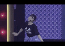 a woman wearing a t-shirt that says ' i love you ' on it is dancing on a stage