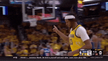 a basketball player wearing a number 33 jersey is giving a thumbs up